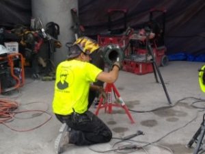 Construction crew checking equipment at an industrial site.