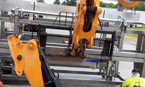 MJ Nester employees putting a large machine together in an industrial site.