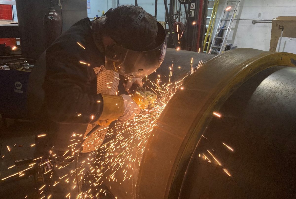 Precision at work: M.J. Nester's skilled technicians expertly grinding welds to ensure smooth, flawless surfaces and strong, reliable joints in your industrial projects. Employee grinding welds down.