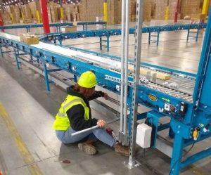 mj nester electrician examining the conveyor electronics, mechanical services