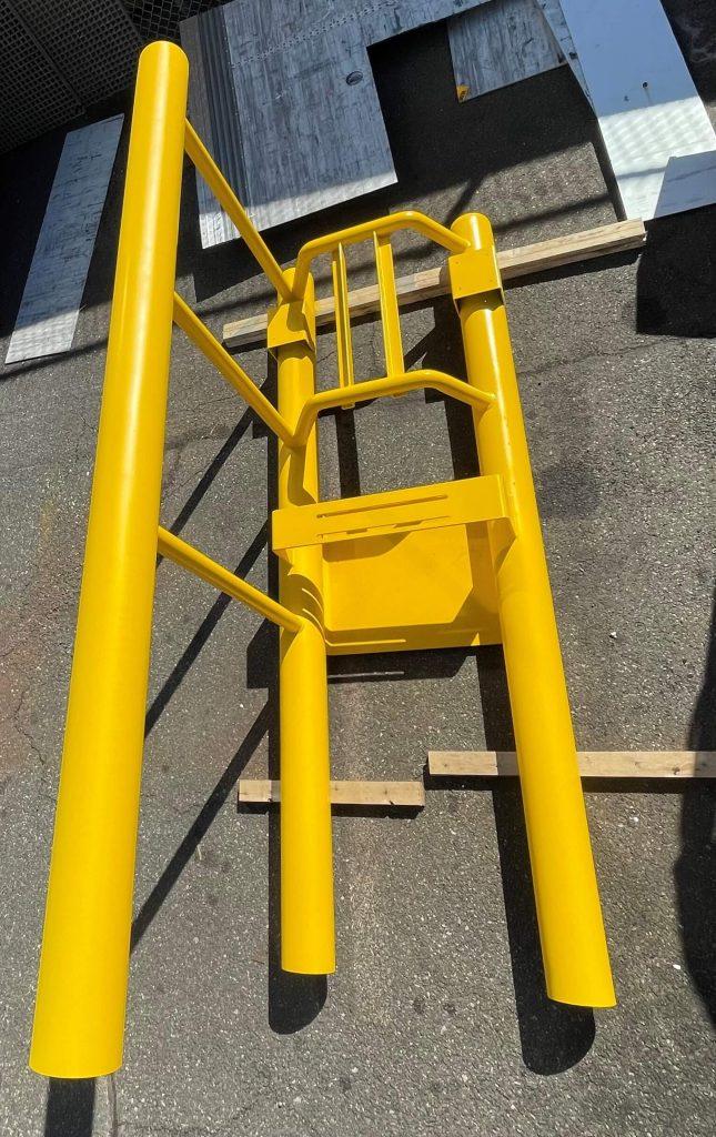 Yellow dock stanchion about to be installed