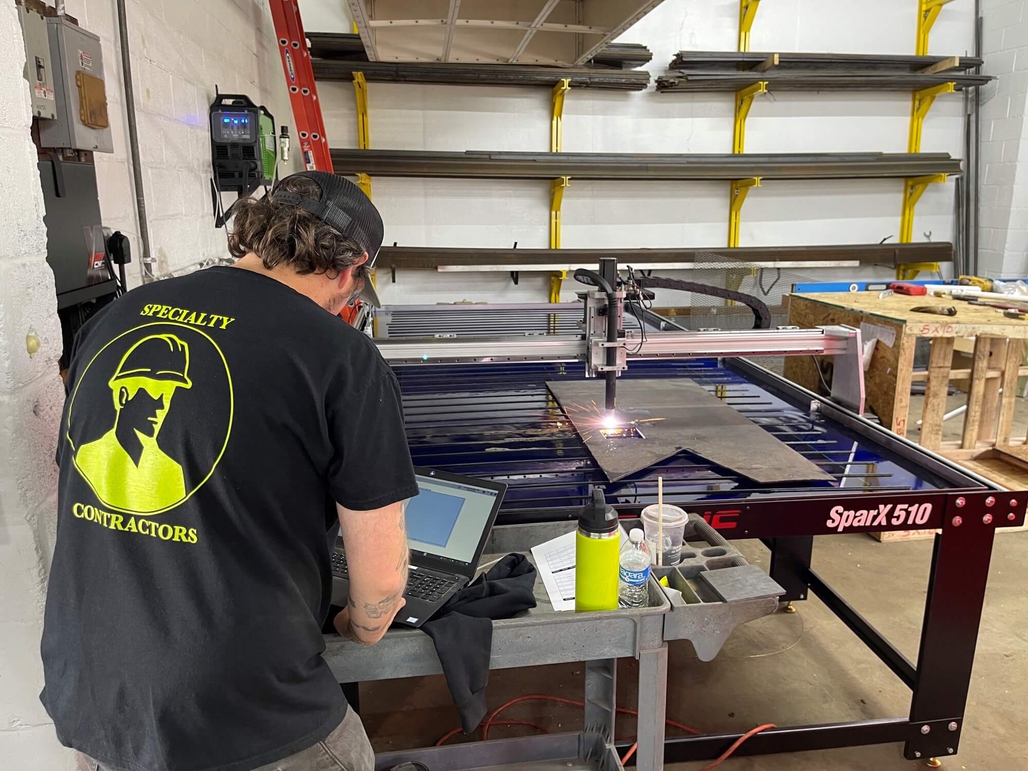 mj nester specialty contractor using a laptop connected to the plasma table to cut a sheet